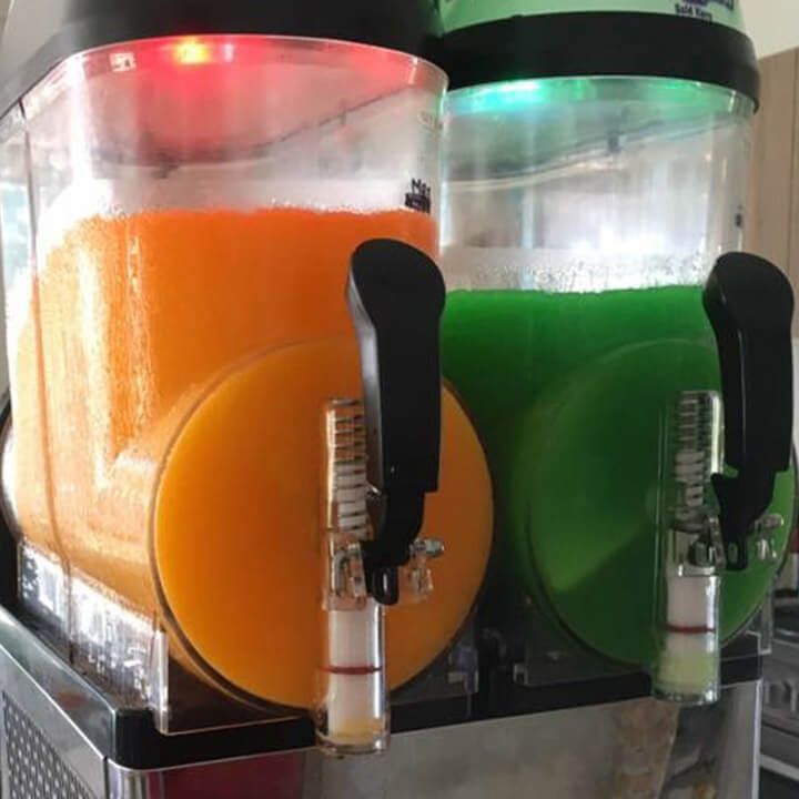 Orange and green slushie machines.