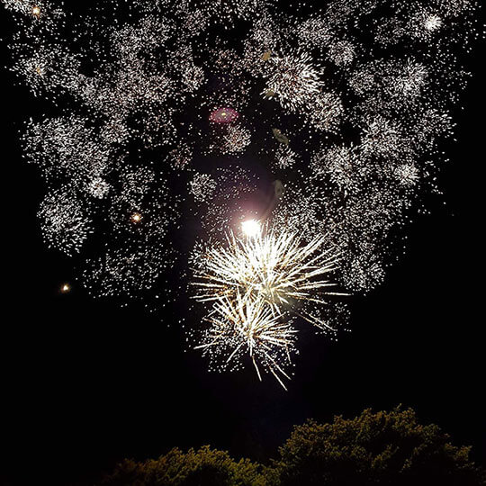 Crackling outdoor fireworks display.