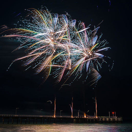 Fireworks at an event over water.